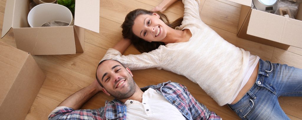 married couple moving boxes pose