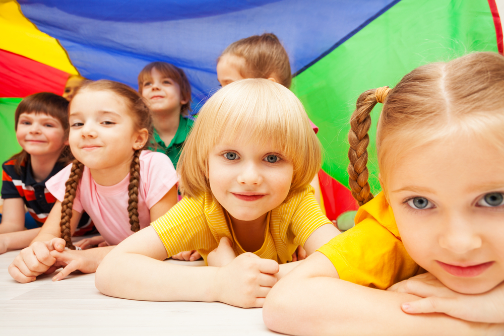 Evaluating school districts before moving: Children playing on the floor at daycare facility